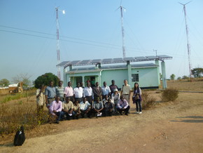 A solar-windhybrid power generation facility in Malawi is in the background.