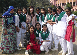 The writer (fourth from the left) is surrounded by female junior high-school students at Ahsan Manzil.