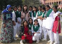 The writer (fourth from the left) is surrounded by female junior high-school students at Ahsan Manzil