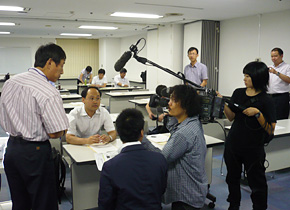 The seminar participant of the Strategic Development Department of the Shanghai City Energy Conservation Center, is interviewed by a TV station.