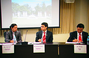 At his seminar, Mr. Koshkarbayev, center, describes the state of energy conservation in his country, together with seminar participants from China and Sri Lanka.