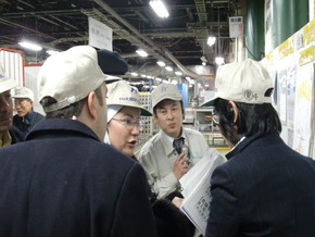 Participants listen intently to an explanation of a case of Kaizen at a factory of Fuji Seat Co..