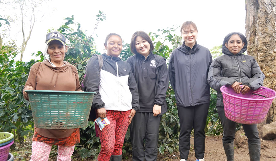 Ms. Hikaru (center) with a woman from a local farm