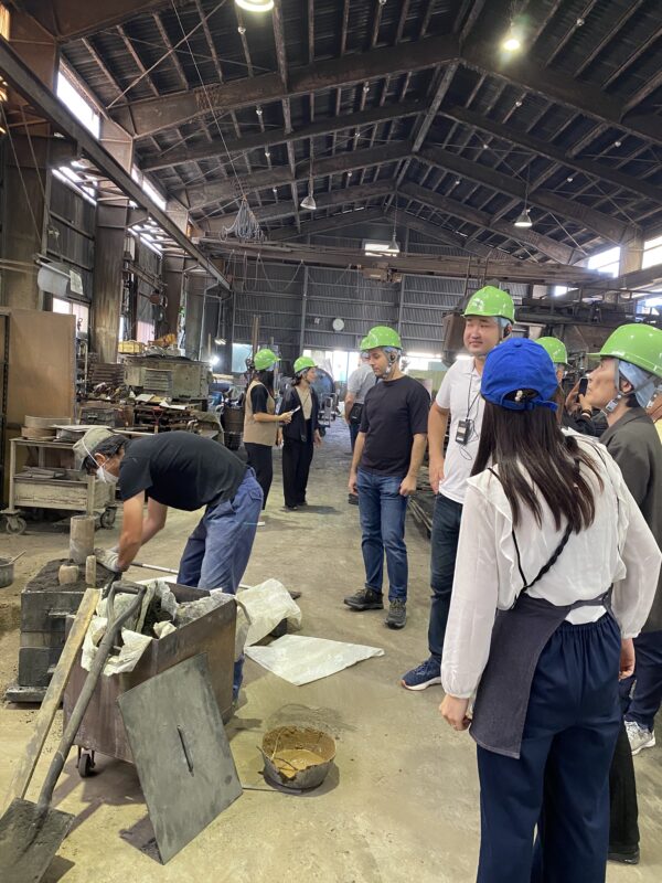 (株) 金森合金：金沢の鋳物工場内を見学する研修員